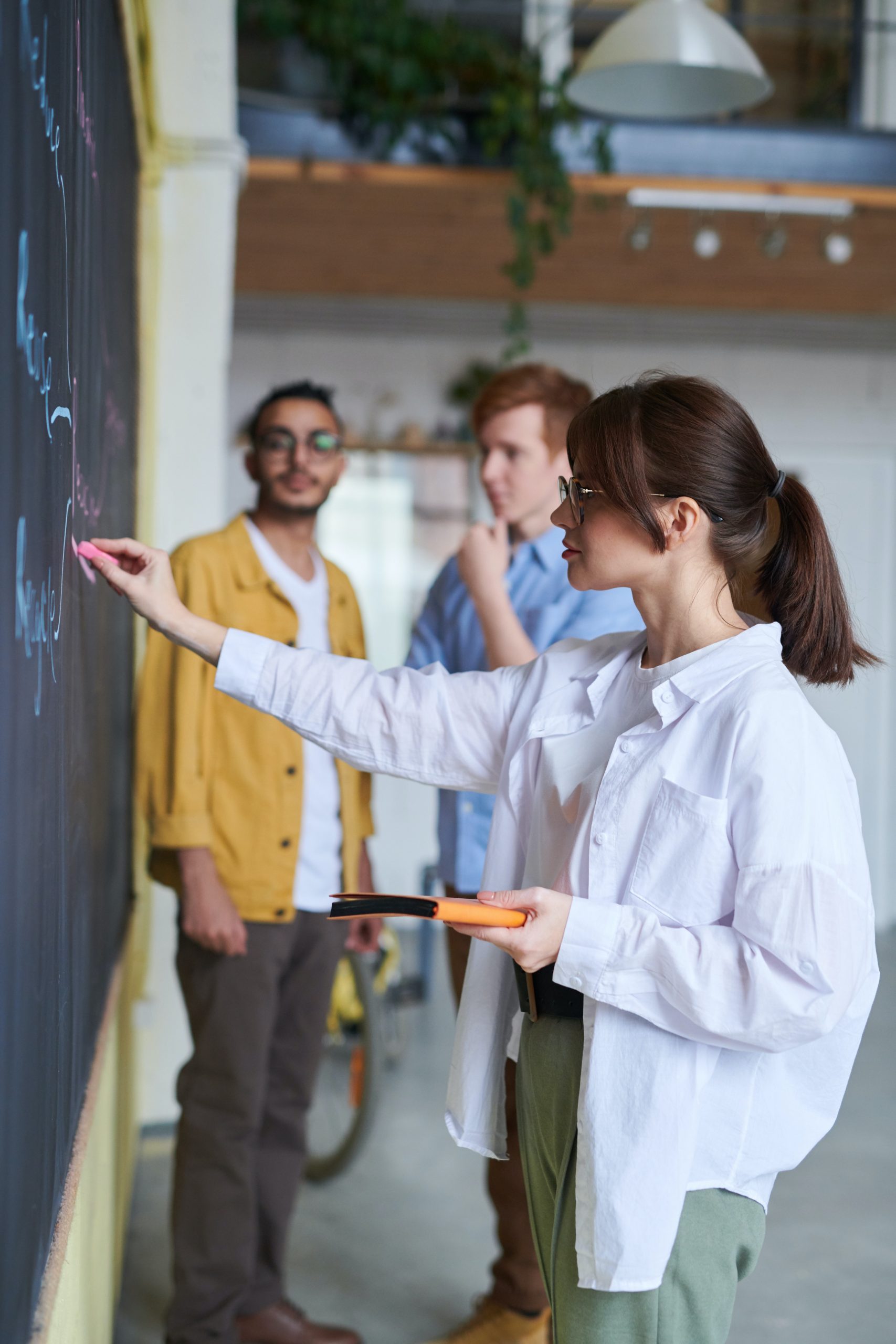 Woman writing on a chalkboard