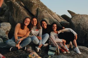 A group of girls sitting on a rock